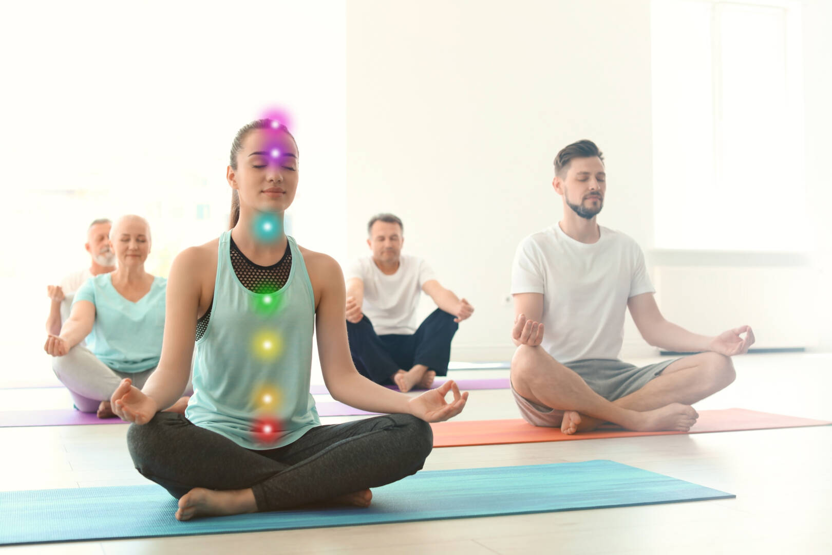 Young,Woman,With,Chakra,Points,Practicing,Zen,Yoga,In,Group